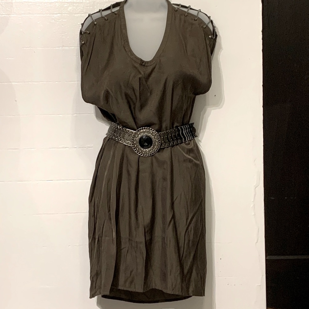 Green dress with studded chain shoulder straps.